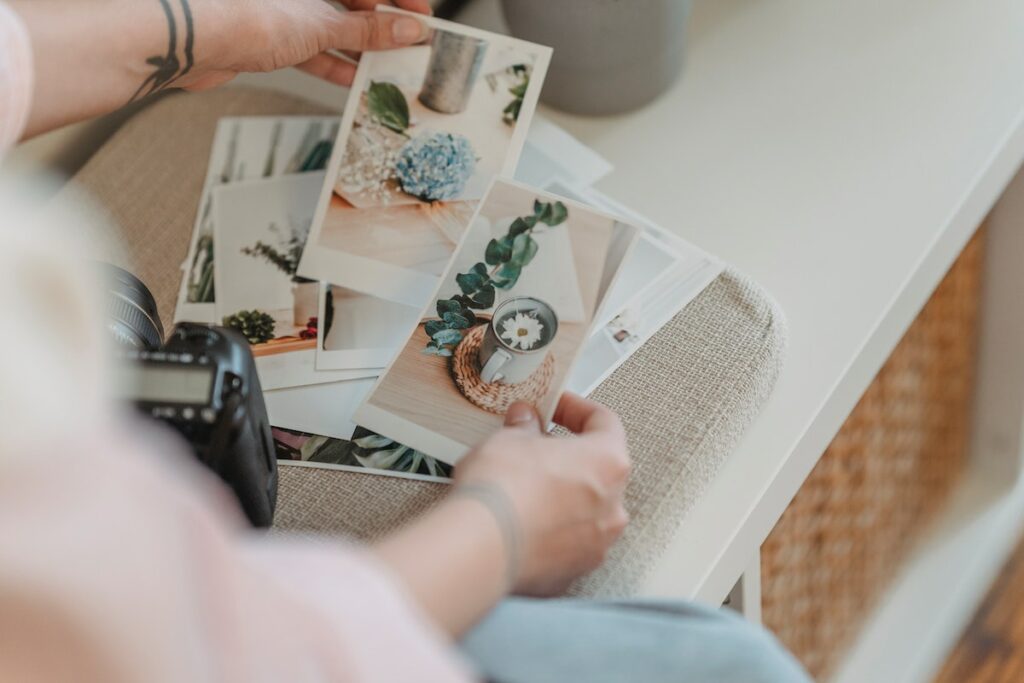A woman displaying personal touch printing photos on a table.