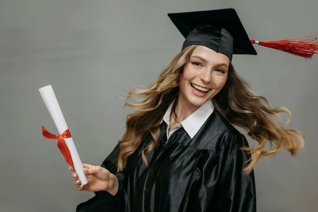 A young woman in graduation gown holding a diploma, featured in a DVD showing.