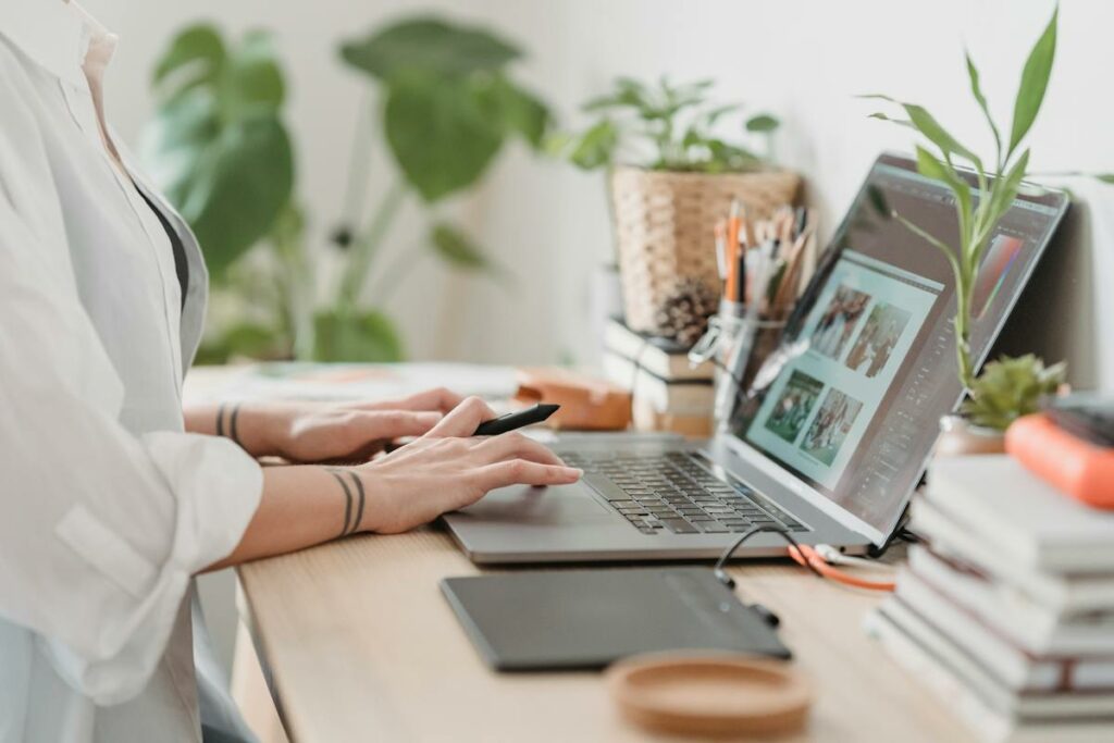 A woman is working on her laptop at home while using Personal Touch Printing.