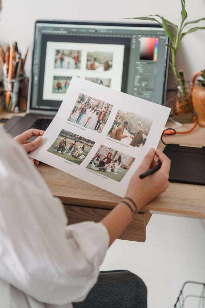 A woman is sitting at a desk looking at Christmas cards.