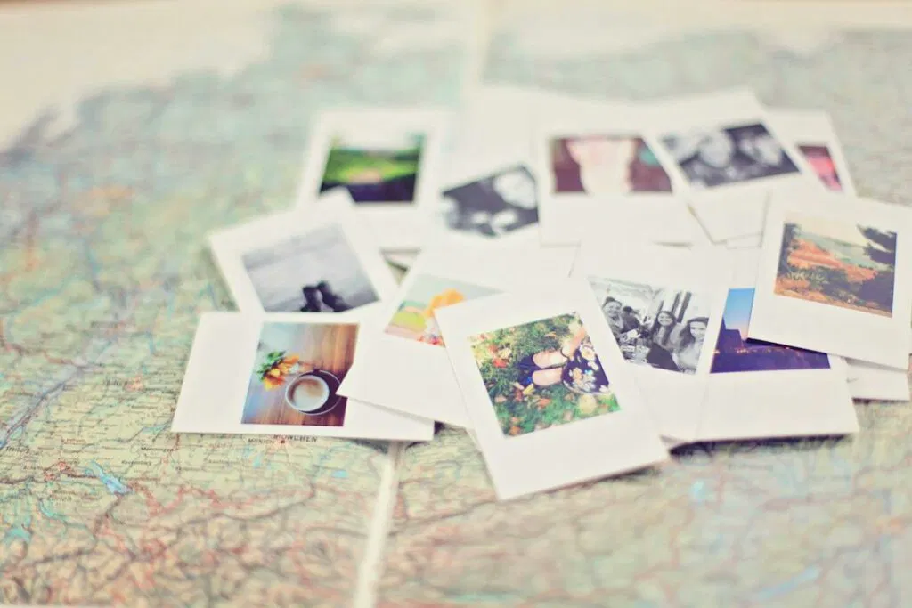 Polaroid photos on top of a map, showcasing a collection of nostalgic memories captured through photo printing.