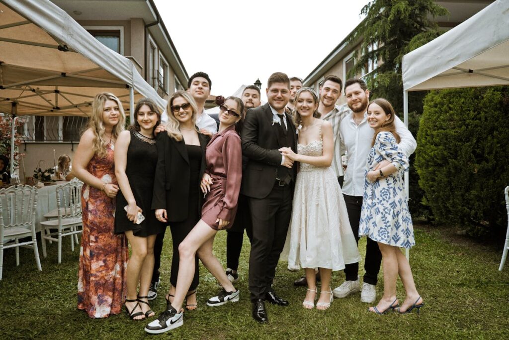 A group of people posing for a photo at a wedding, with Party Photos Printing On Site.